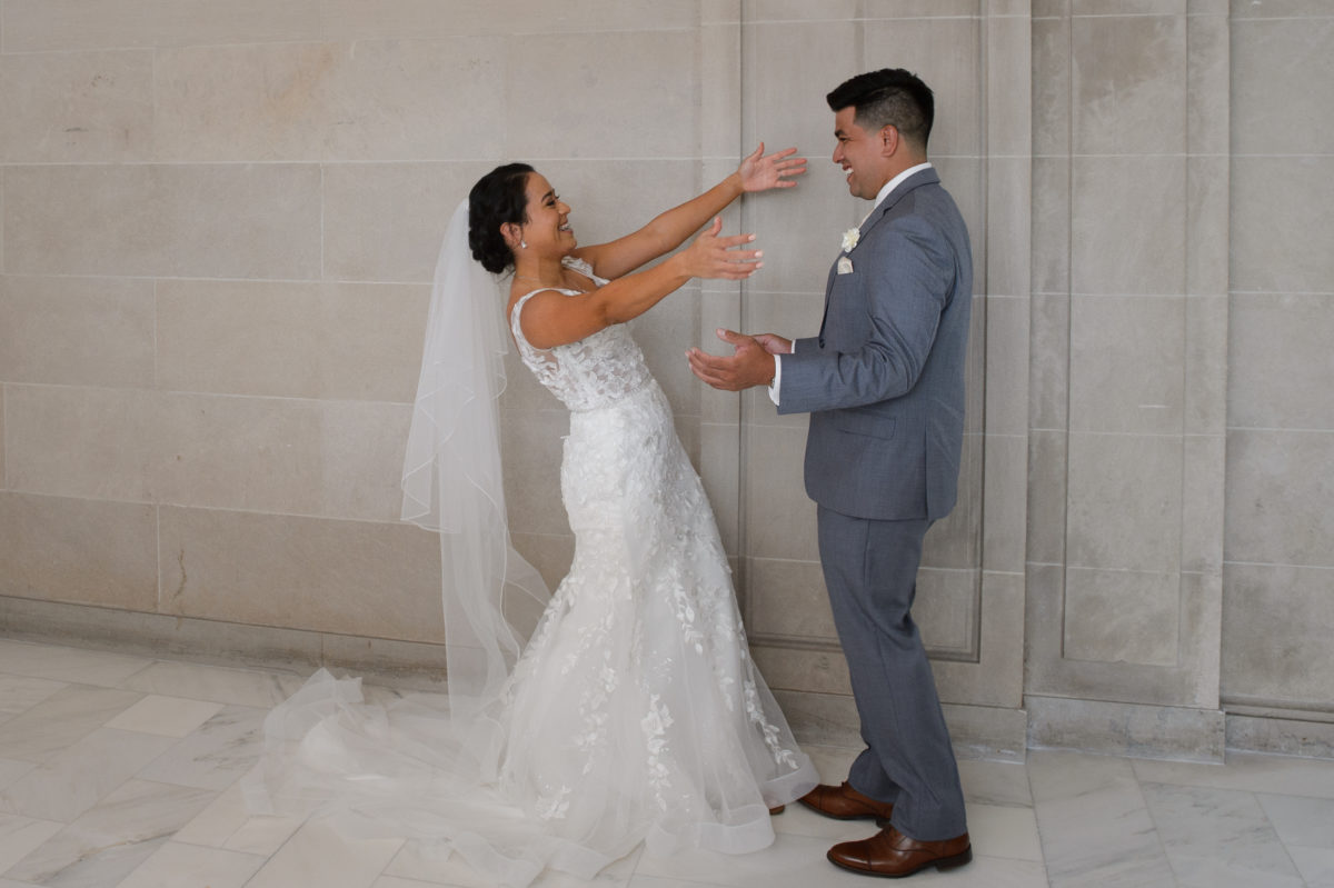 Bride and groom seeing each other for the first time before the wedding.  First Look.